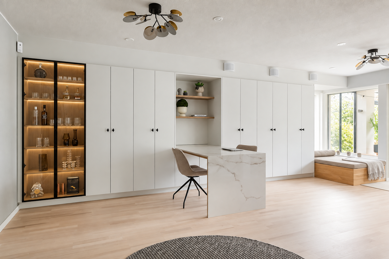 White built-in cabinetry with a glass display cabinet and marble desk at Pohtola House